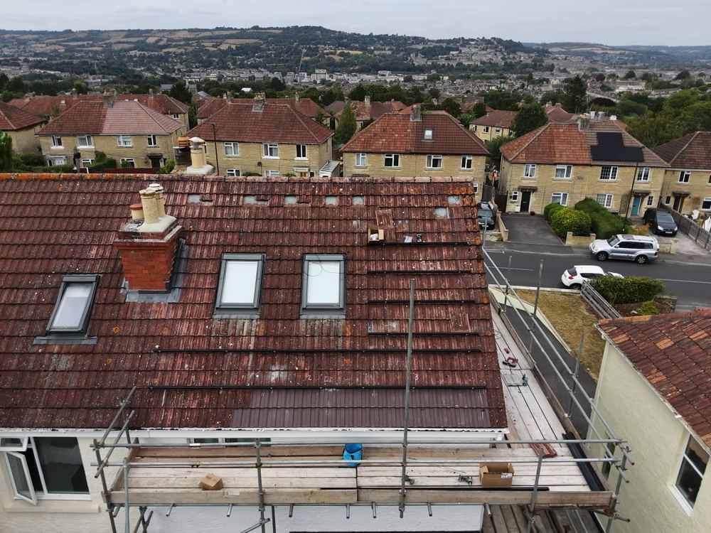 Cube Solar working above Bath's rooftops, with the city and surrounding hills behind