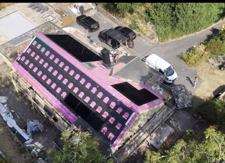 Drone view of a Bath bungalow mid re-roof, with GSE in-roof solar panels going in on both slopes