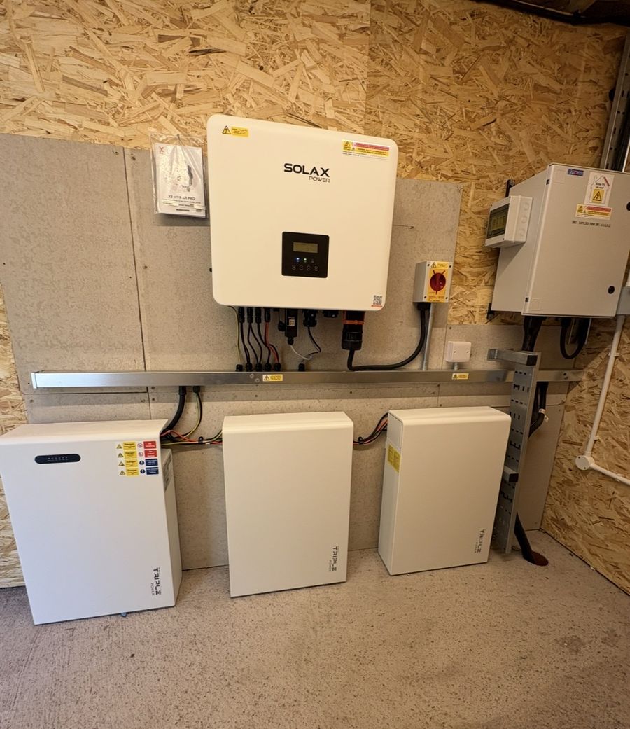 SolaX hybrid inverter and three Triple Power battery modules installed in the plant room