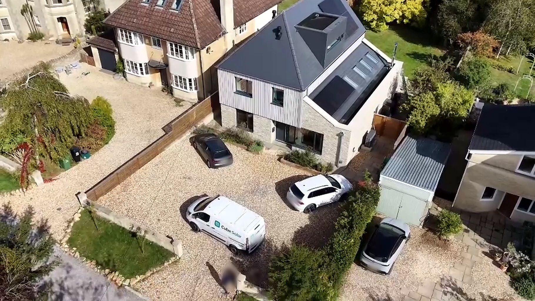 Drone view of a Cube Solar installation on a contemporary house in Claverton, Bath, with the Cube Solar van on the drive